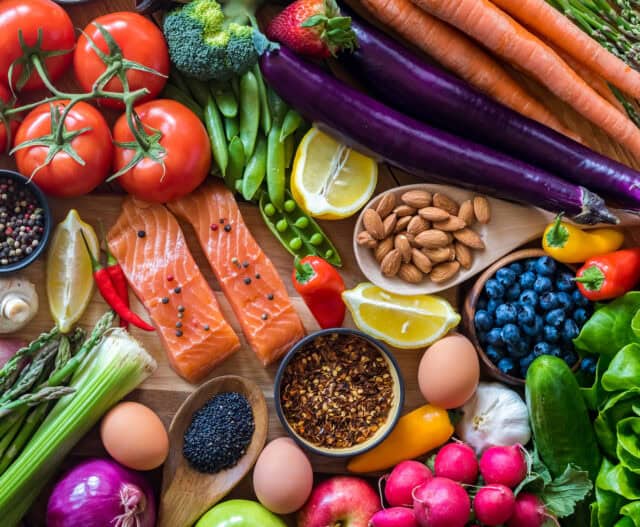 Person preparing fresh vegetables and healthy ingredients as part of a personalized diabetes prevention meal plan.